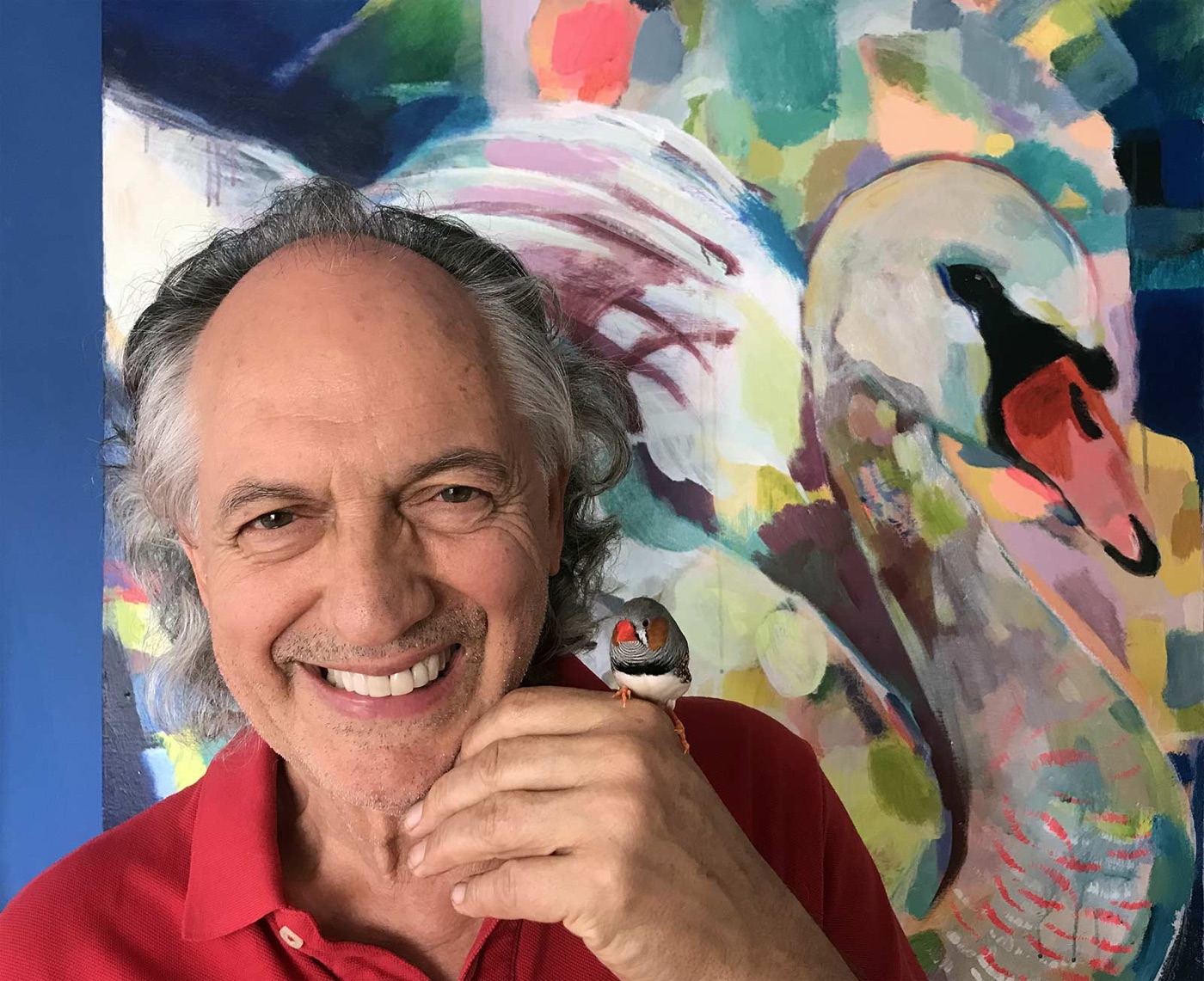 Crispin Kitto with a finch, in front of a painting of a swan